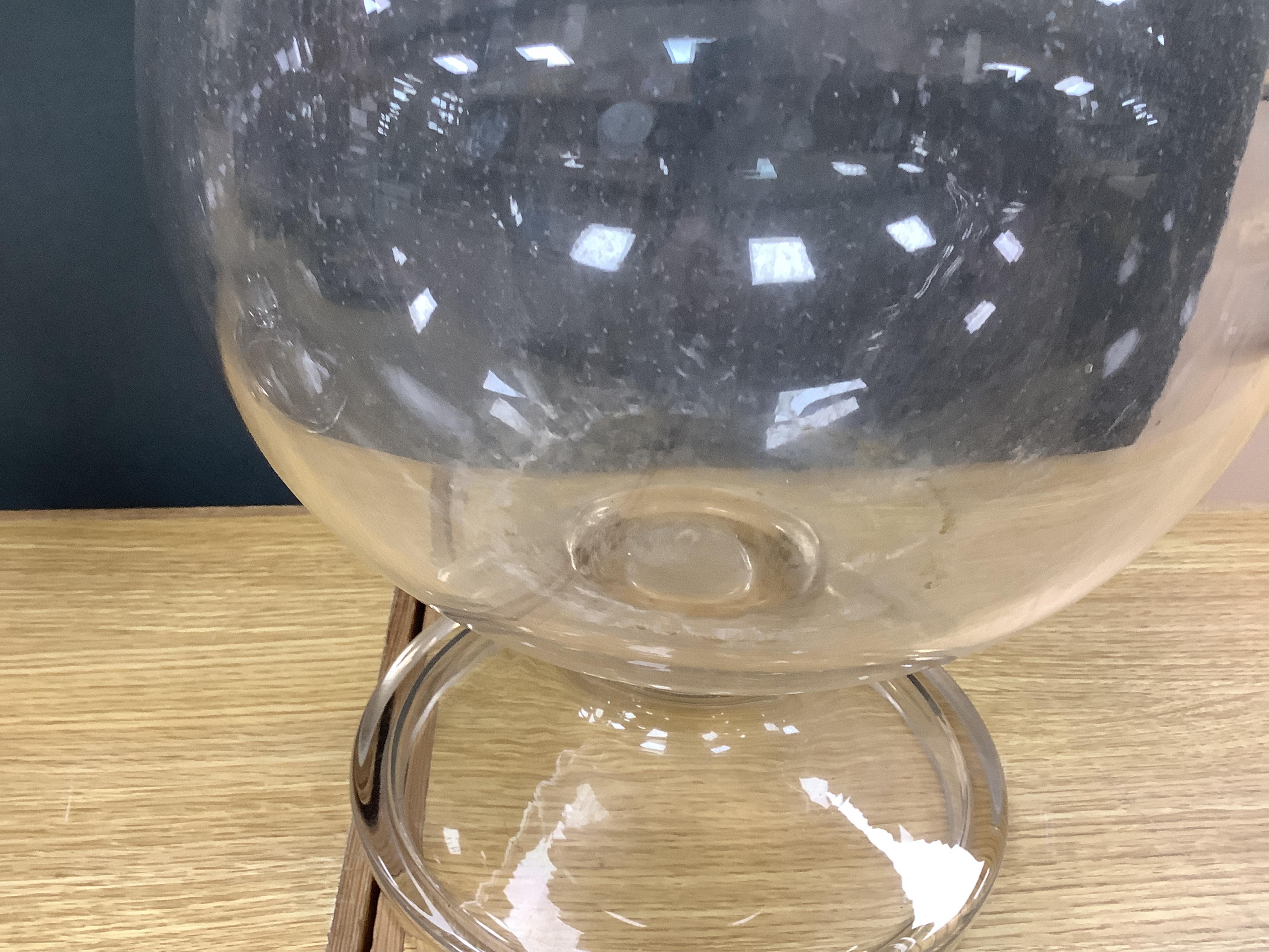 A pair of large clear glass chemist window display bottles and stoppers, one with chip, 90cm high